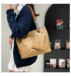 Close-up of stylish printed tote bag set with matching small zipper pouch and leather straps
