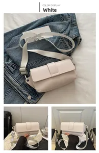 Detailed view of white faux leather crossbody bag with wide adjustable fabric strap