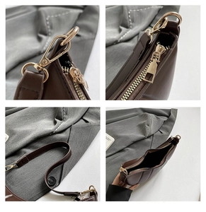 Detail view of smooth zipper and golden hardware on dark brown faux leather bag