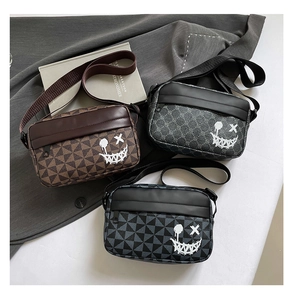 Three geometric patterned crossbody bags with graffiti smiley face and wide nylon straps