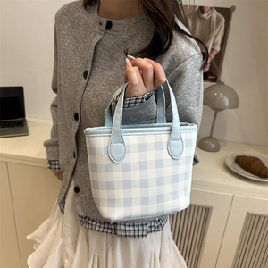 Chic blue and white plaid handbag with top handles for women in a casual indoor setting
