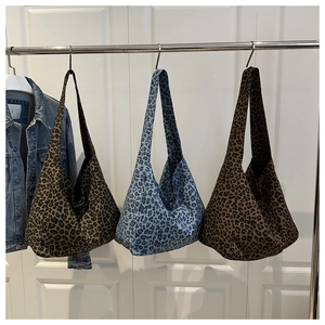 Detailed view of leopard print canvas tote bags in khaki, light blue and coffee brown