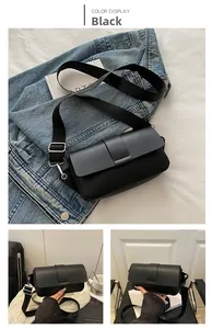 Detail of black matte leather bag with adjustable wide strap and silver metal hardware
