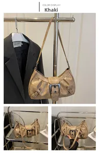 Detail view of khaki distressed leather underarm bag with metal buckle and rivets
