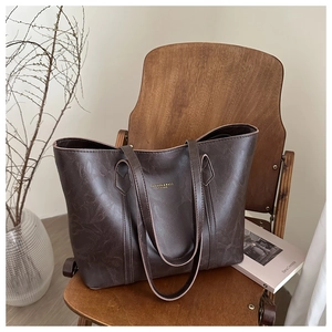Minimalist large brown tote bag on a vintage chair with a modern artistic background