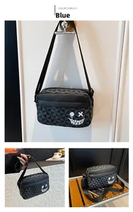 Detail of blue crossbody bag featuring a geometric triangle pattern and white graffiti smile