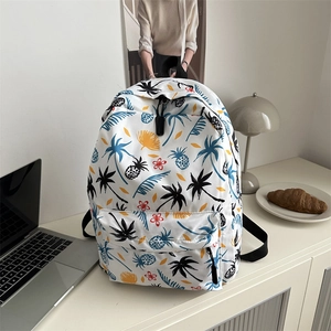 Tropical print school backpack for women featuring colorful palm trees and pineapple patterns