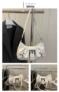 Detail of white vintage motorcycle style shoulder bag with metallic buckle and glossy finish