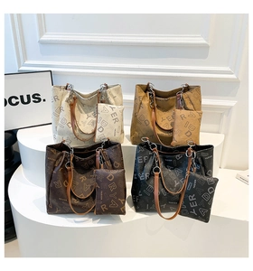 Détail de cabas en cuir multicolores avec motif monogramme et petites pochettes assorties