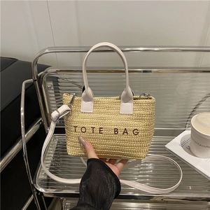 Straw woven tote bag with TOTE BAG embroidery and white faux leather handles and strap