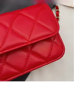 Detailed close-up of red quilted leather texture and gold chain strap of the crossbody bag