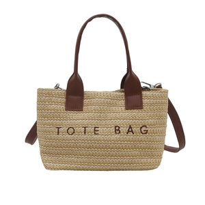 Woven straw tote bag with brown leather handles and Tote Bag embroidery for summer