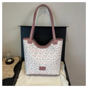 Gros plan du motif floral rose sur cabas en toile avec étiquette en cuir FASHION BAGS