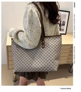 Close-up of vintage monogram tote bag with brown leather handles and spacious interior
