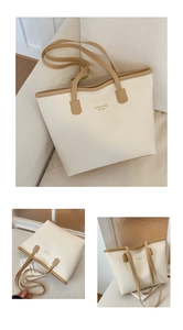 Vistas detalladas del bolso tote crema con asas marrones y letras de New York