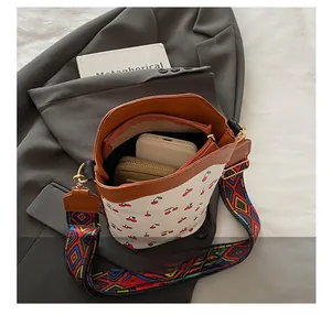 Detail of cherry print bucket bag interior with a phone and wallet showing large capacity