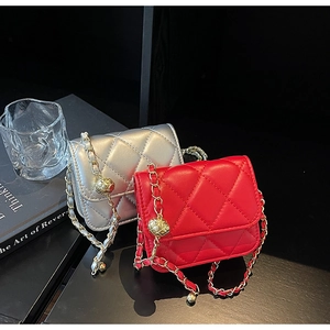 Detail view of mini quilted flap bags in red and silver with golden ball chain adjusters