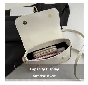Internal view of beige crossbody bag showing capacity for wallet and accessories
