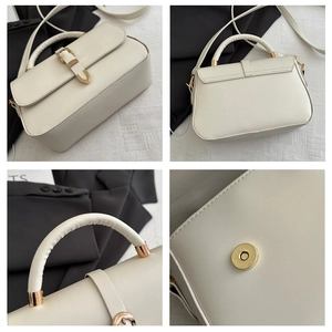Detail of cream white leather bag showing horseshoe buckle and magnetic closure