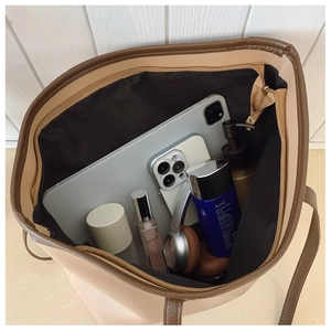 Top view of spacious tote bag interior showing capacity for laptop and cosmetics