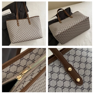 Macro detail of vintage monogram tote bag with leather straps and gold metal zipper