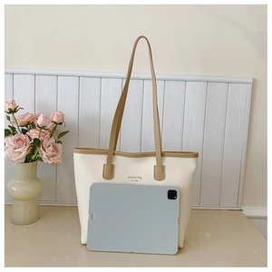 Spacious off-white tote bag showing interior capacity with an 11-inch tablet device