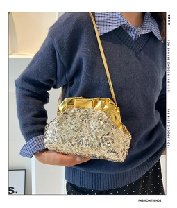 Detail of champagne gold sequin evening bag with metallic pleated closure and chain