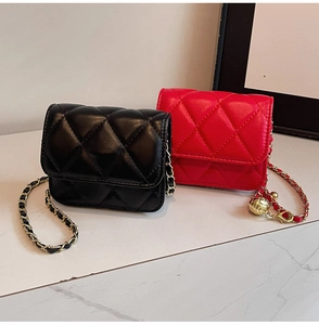 Detail of quilted mini crossbody bags in black and red with metal chain straps