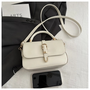 Detail of minimalist cream PU leather crossbody bag with smartphone for size comparison