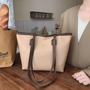 Retro contrast tote bag in beige and brown leather shown in a lifestyle home setting