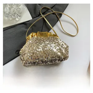 Detailed close-up of shiny gold sequins and pleated leather edge on a mini shoulder bag