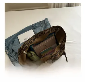 Detailed interior of leopard print canvas tote bag showing large storage capacity