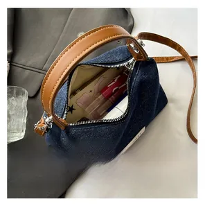 Detail view of denim handbag interior showing capacity for daily makeup items