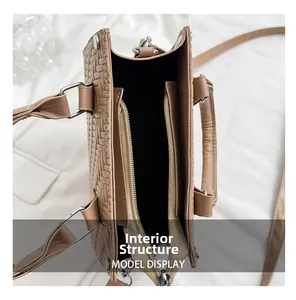 Internal structure of the tan woven tote bag showing double zippered compartments and strap