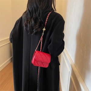 Red quilted leather mini crossbody bag with chain strap and diamond stitching