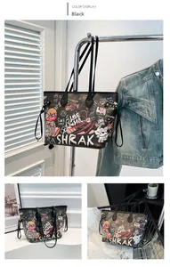 Detail of black leather tote bag with colorful teddy bear graffiti and drawstring design