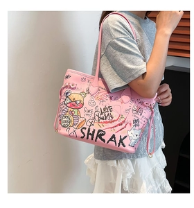 Close-up of pink tote bag featuring artistic graffiti prints and high-quality leather texture