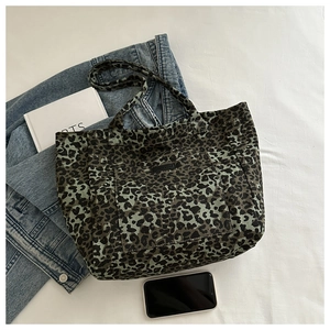 Leopard print canvas tote bag detail with front pocket on casual background