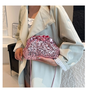 Detail of pink sequin cloud bag featuring pleated trim and shimmering metallic finish