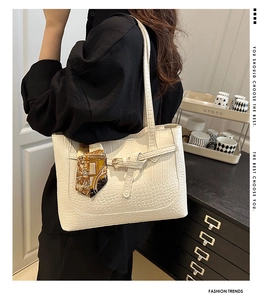 White crocodile pattern tote bag featuring decorative buckle and elegant silk scarf detail
