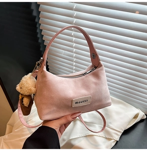 Pink matte crossbody bag with MDDJ37 label and a cute brown teddy bear pendant detail