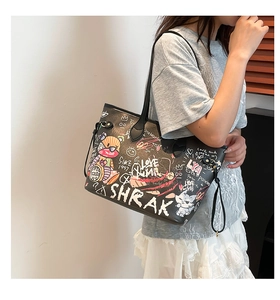 Detail view of large tote bag with colorful graffiti prints and street art style