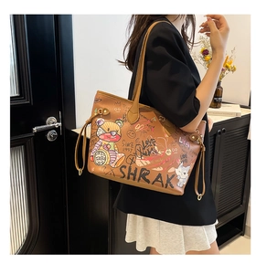 Detail of vintage brown tote bag with colorful graffiti and bear patterns
