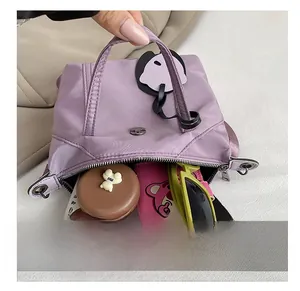 Detailed interior of nylon tote bag showing storage capacity for phone and sunglasses