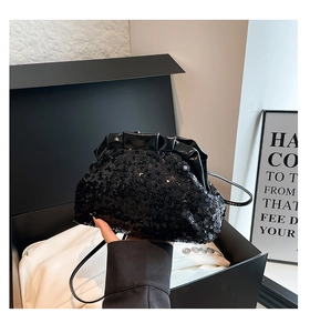 Detailed close-up of a black sequin cloud bag with glossy pleated finish and shoulder strap