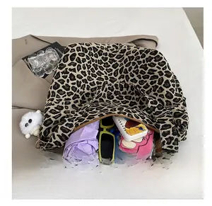 Detail showing high-capacity interior of leopard print tote bag with daily essentials