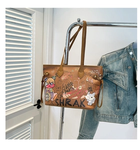 Detail of a brown tote bag with colorful street graffiti and character prints on a metal rack
