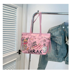 Pink graffiti tote bag with shoulder straps hanging in a stylish lifestyle setting