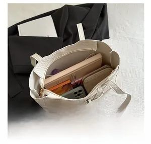 Interior view of white crocodile pattern tote bag showing large capacity and zipper pocket