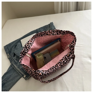 Macro detail of spacious pink leopard print canvas tote bag showing interior storage capacity